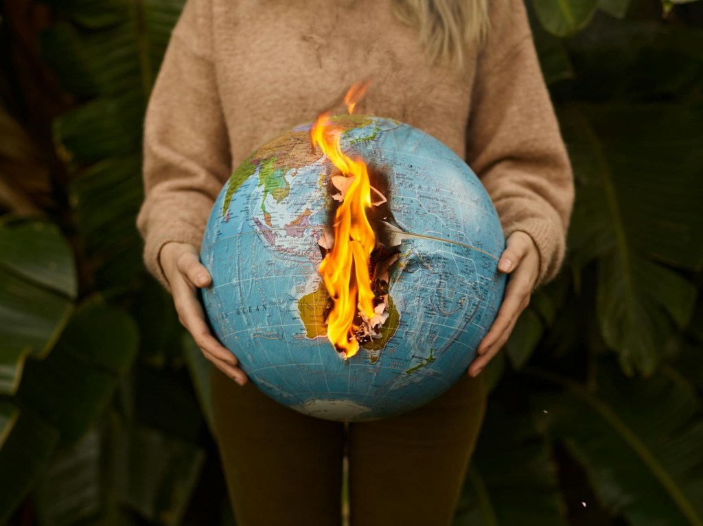 A globe on fire, illustrating the mess the liberals (aka the neoliberal and fascist enablers) have done to humanity and our planet.